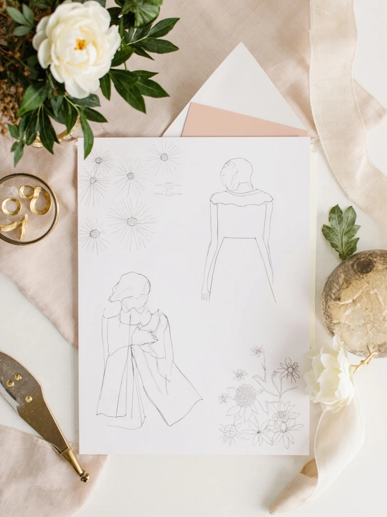 A designer's desk with hand-drawn floral sketches