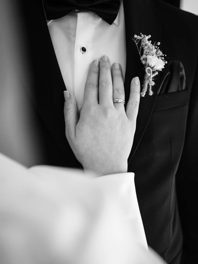 A bride's hands resting quietly at a window