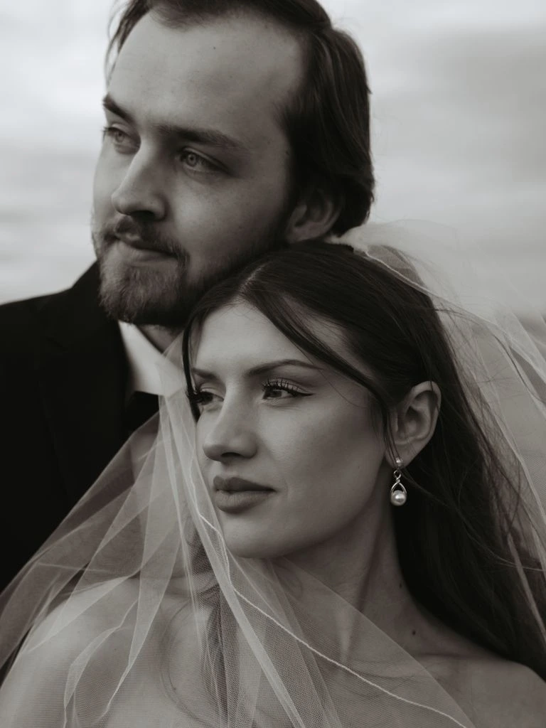 A bride and groom at golden hour on a coastal terrace in Portugal